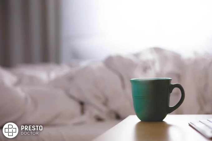green ceramic mug on wooden desk, smoking weed with a cold