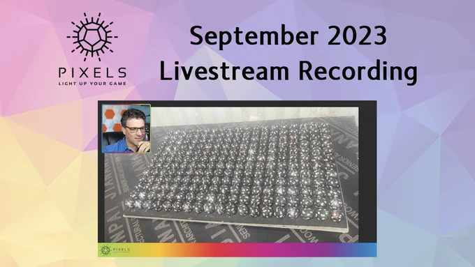 Screen shot of livestream with Jean as a small picture in picture insert above a photograph of a full tray of 200 completed Midnight Galaxy d20s. Above is the Pixels logo and text September 2023 Livestream Recording.