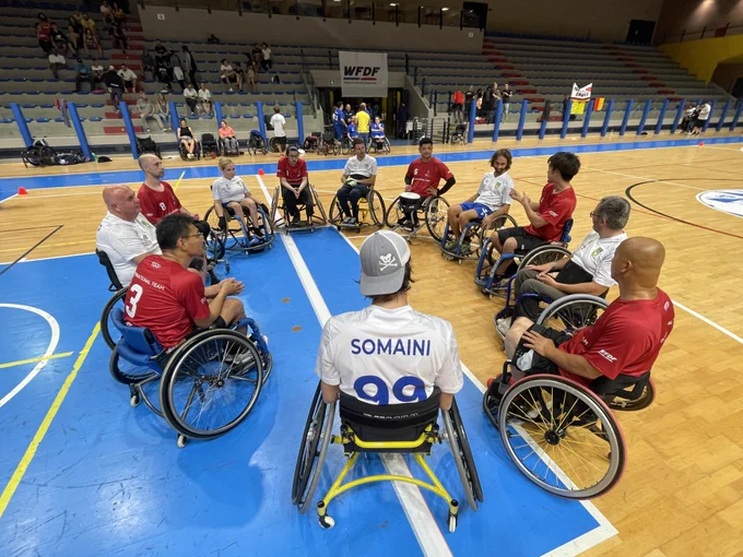 Teams have a spirit circle at the WFDF 2023 World Wheelchair Ultimate Championships.