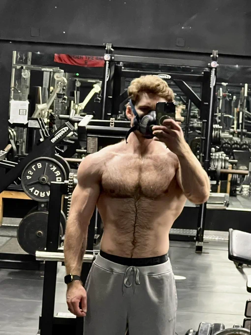 Picture of myself shirtless in an empty gym, pumped and wearing a respirator.