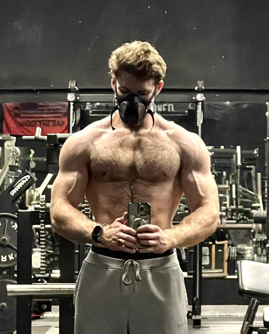 Picture of myself shirtless in an empty gym, pumped and wearing a respirator.