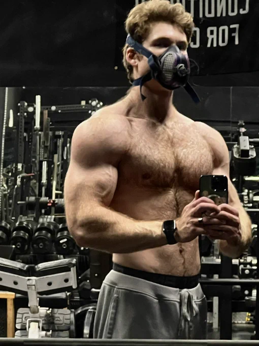 Picture of myself shirtless in an empty gym, pumped and wearing a respirator.