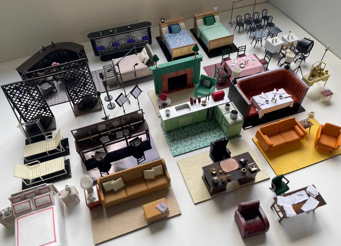 Image is of numerous miniature pieces of furniture. These are the models of the set designs for Sinatra The Musical. 
