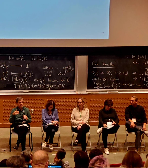 Paul Gronke and others in front of a blackboard at MIT during a panel discussion