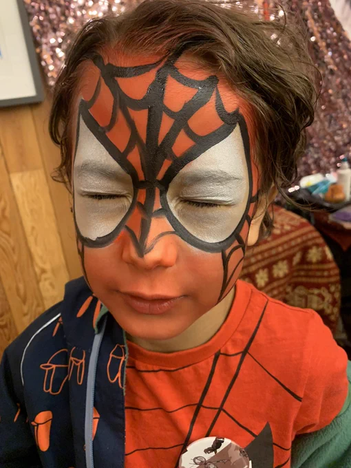 Spider-man face paint on my child.