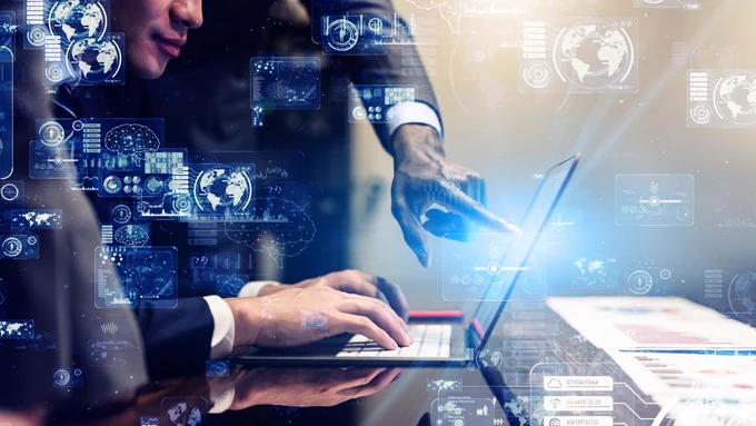 A rather poor stock photo of one person staring at a laptop screen, and another person leaving a smudge on it by pointing on it.