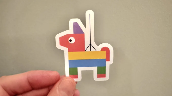 Donkey piñata sticker being held up by a hand