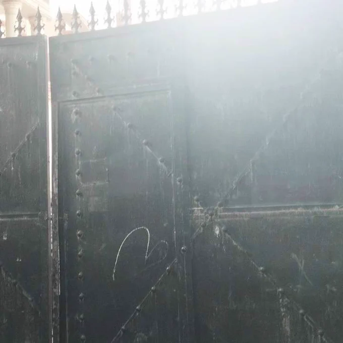 A foreboding black 6ft  gate is shut, shutting the entry to TCLP's Khirki library