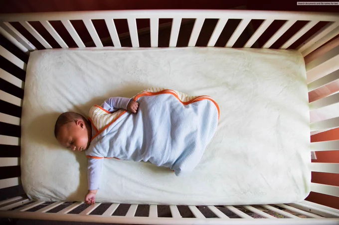 A baby sleeping in a crib.