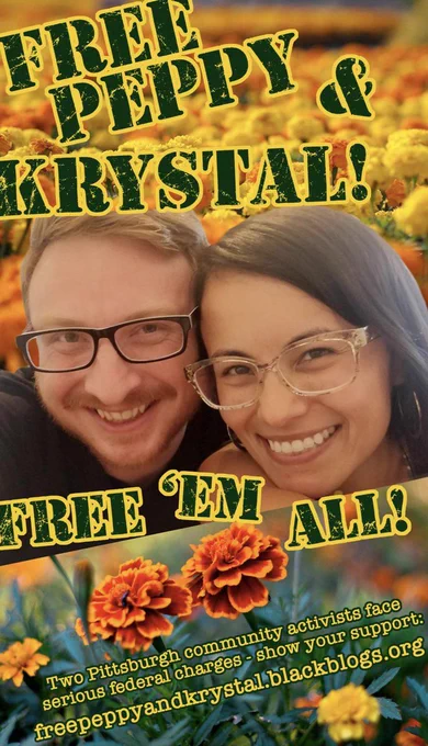 A vibrant support poster with flowers and a picture of Peppy & Krystal side by side. At the top it says "Free Peppy & Krystal!" and at the bottom it says " Free 'Em All! " and under that it has the url for the support site which is freepeppyandkrystal.blackblogs.org 