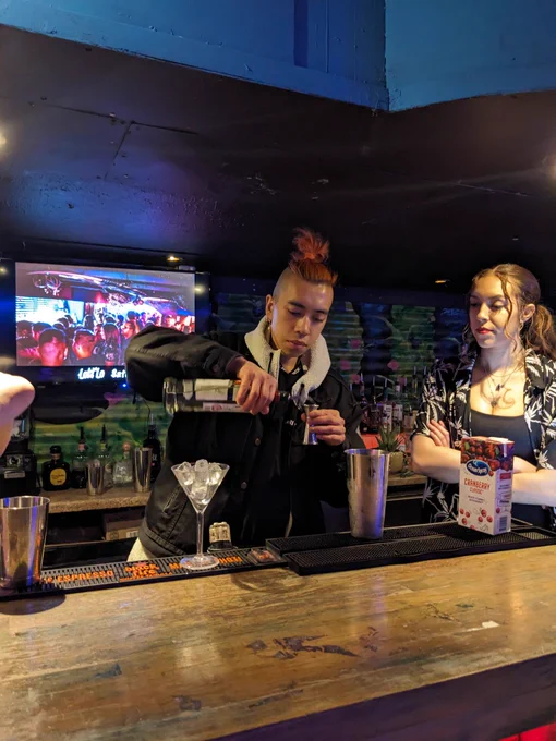 Minh being a cocktail making pro behind the bar 