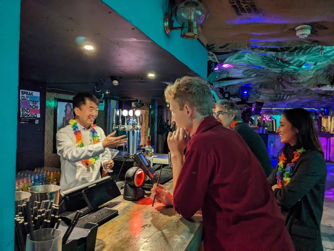 Head of group Meng, being a hit bartender, making his "customers" laugh. 