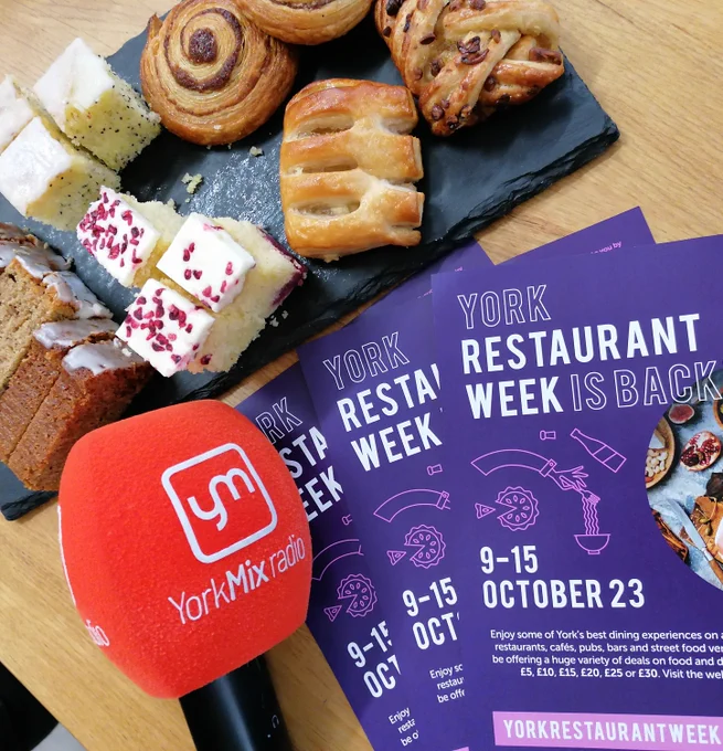 A platter of cakes, the YorkMix radio microphone and some York Restaurant Week leaflets