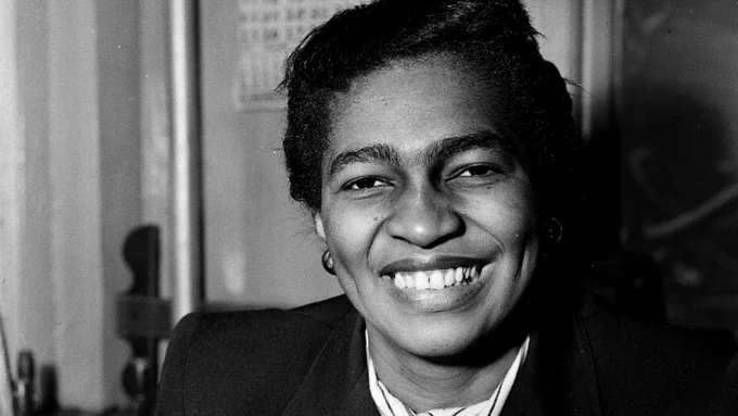 A picture of Claudia Jones smiling directly at the camera