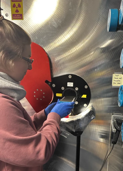 Scientist x raying a split core of sediment.