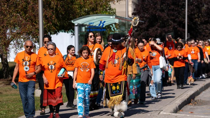 Edler Myeengun Henry, Vivek Goel and Jean Becker leading the orange t-shirt walk around Rind Road 