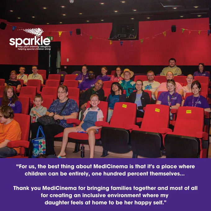 A photograph of our MediCinema theatre - Children, young people, parents/carers and Sparkle staff all sit in the seats and smile at the camera, ready for the film to start. Below the image reads a quote: "For us, the best thing about MediCinema is that it's a place where children can be entirely, one hundred perfect themselves... Thank you MediCinema for bringing families together and most of all for creating an inclusive environment where my daughter feels at home to be her happy self."