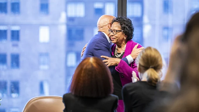 Ruth J. Simmons hugs Darren Walker on stage