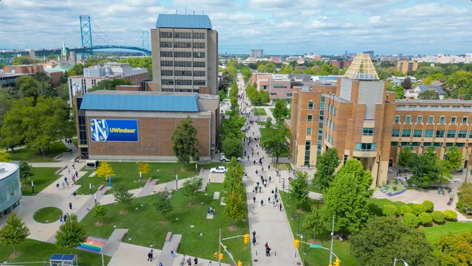 Aerial of UWindsor campus with students and members of campus walking.