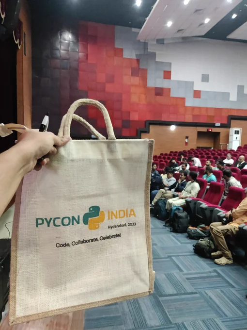 A volunteer de briefing ongoing at PyCon India with the swag bag 