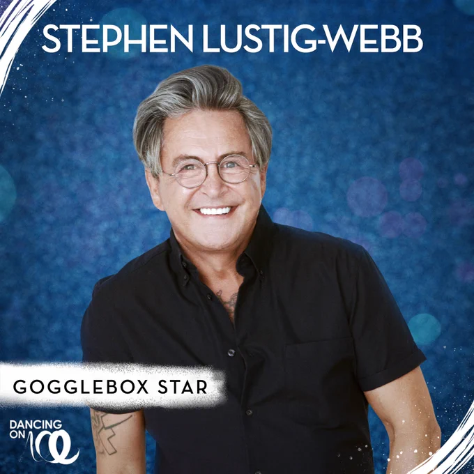 Stephen Webb poses in a black t-shirt against a dark blue glittery background