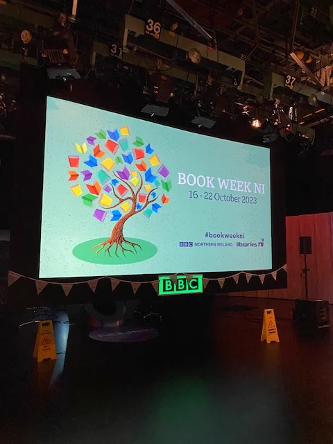 Photograph of a screen with the Book Week NI branding