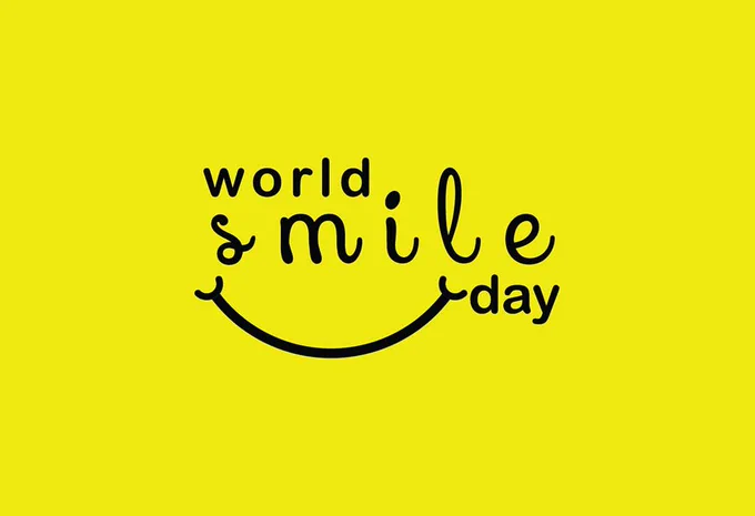 Yellow image with the words 'world smile day' and a small smile under the word 'smile'