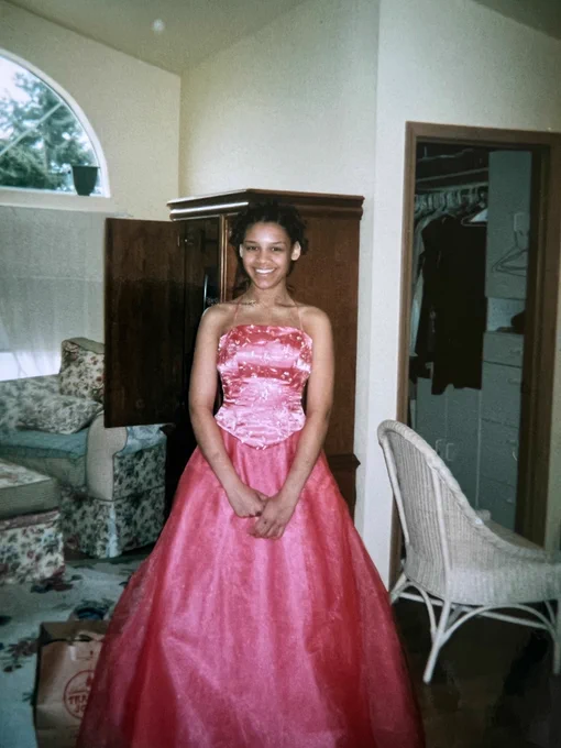Young Addie in a very bright pink prom dress that puffy