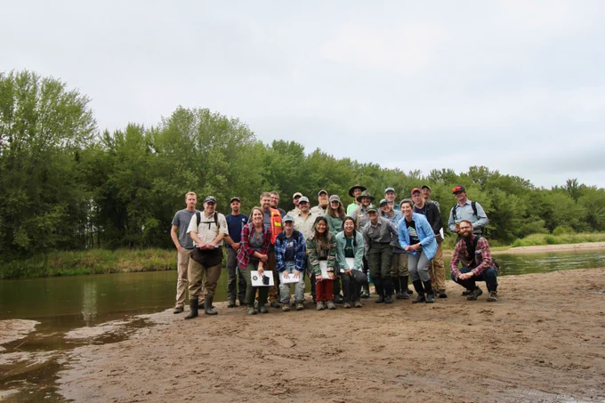 Group photo in front of a river. 