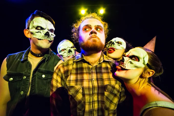 a production photo of Good Grief by Ugly Bucket - four performers in masks lean in to one performer in clown makeup