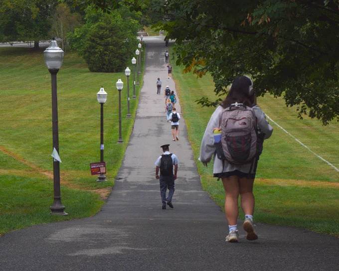 Hokies walk across the Drillfield on a rainy morning. 