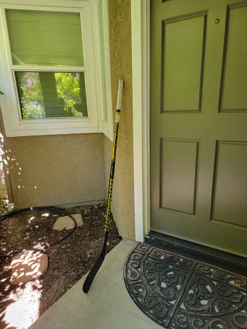 Players stick outside door...commemorating passing of hockey legend