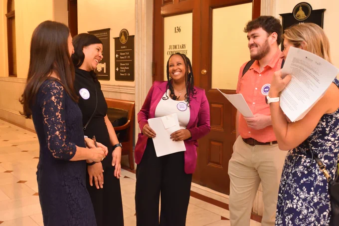 Social workers laughing and chatting before they go lobby to their legislators. 