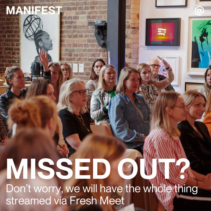 An audience at an event raising hands to ask a question