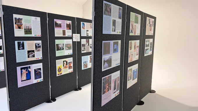 Photographs displayed for viewing in an exhibition room