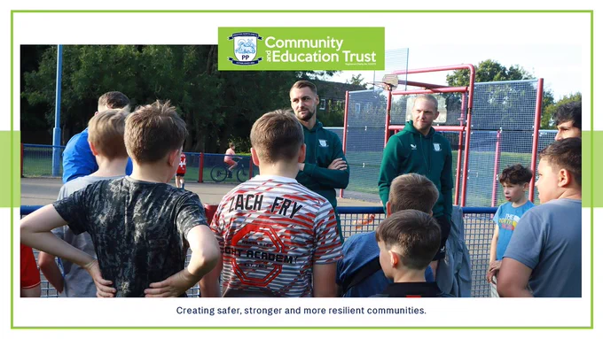 Preston North End players Patrick Bauer (left) and Dai Cornell speak with PNECET Premier League Kicks participants at Moss Side. 