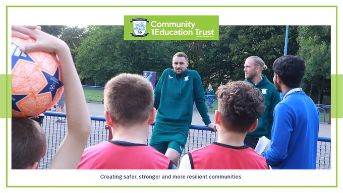 Preston North End players Patrick Bauer (left) and Dai Cornell speak with PNECET Premier League Kicks participants at Moss Side. 