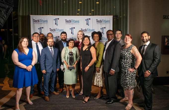 Faculty, staff, and students posing in a group for a photo after winning the award.