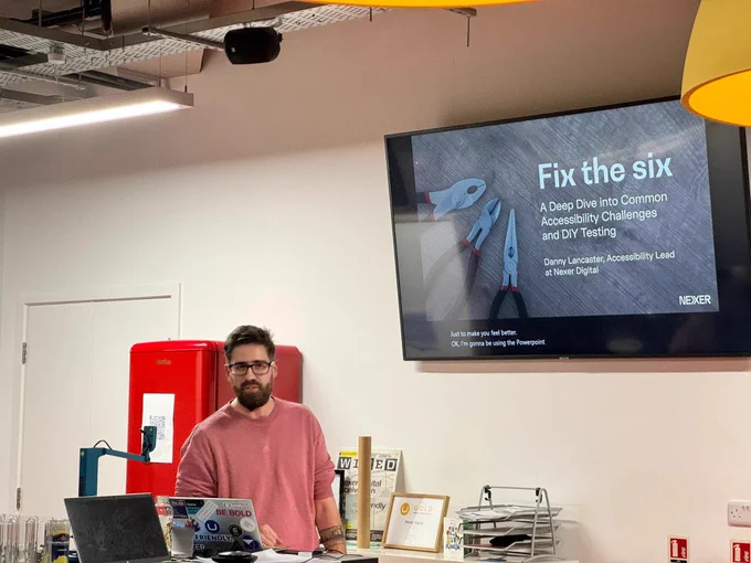 Danny Lancaster making a presentation on a big screen