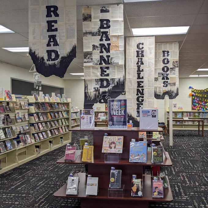 Photo three shows the display at the North Valleys Library with banners above that say Read Banned & Challenged Books.