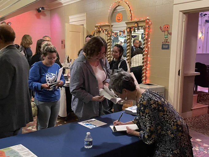 Kimiko Hahn signing books for GVSU Poetry Night at the Wealthy Theatre in Grand Rapids.