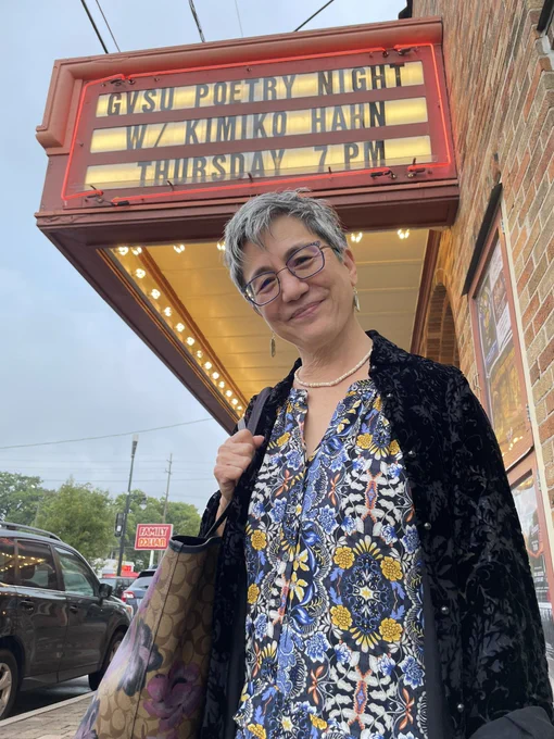 Kimiko Hahn under the marquee for GVSU Poetry Night at the Wealthy Theatre in Grand Rapids.