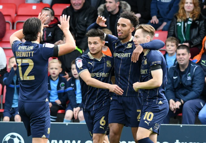Swindon Town players celebrate Remeao Hutton's equaliser vs Salford City