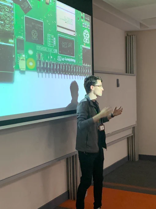 Sam talking to attendees in lecture theatre