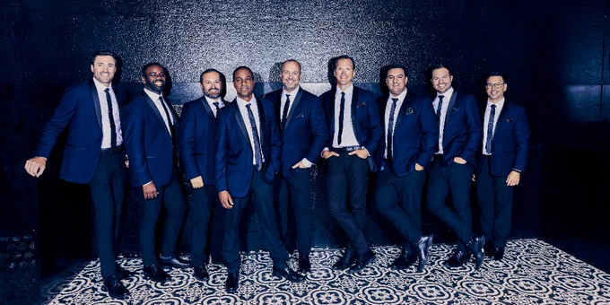 The members of Straight No Chaser pose for a photo.
