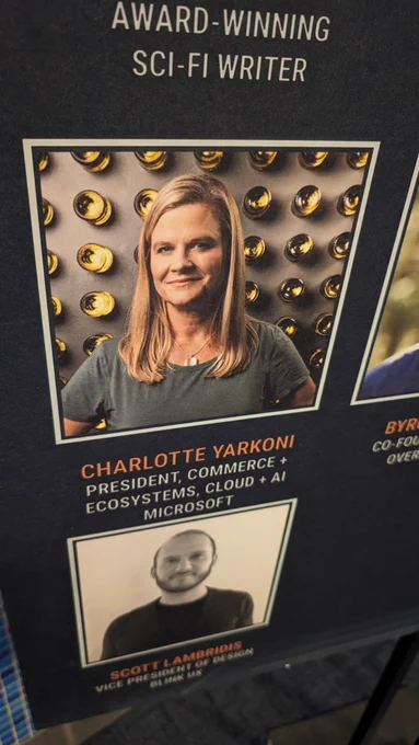 Printed headshot photo of Charlotte Yarkoni (President, Commerce   Ecosystems, Cloud   AI at Microsoft) on a banner at GeekWire Summit on Seattle, WA 