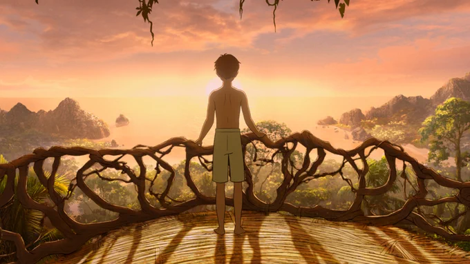 A boy stands on a wooden balcony looking over a beautiful island view made up of forest, mountains and the sea. The sun is setting in front of him. 