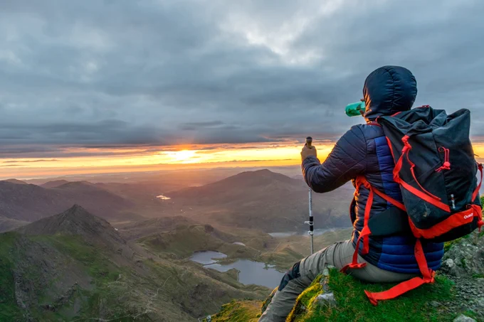 well equipped walker looking out over the mountain in Eryri