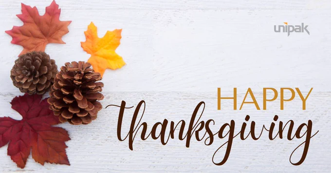 Happy Thanksgiving message with red, orange, and yellow maple leaves and acorn accents.