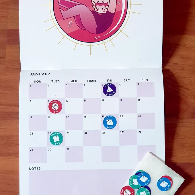 Image of the Dungeon Delves calendar open to reveal polyhedral dice stickers stuck to certain dates as a reminder for game sessions.
